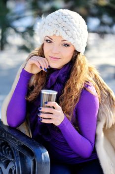 Portrait of beautiful girl in winter with coffee.