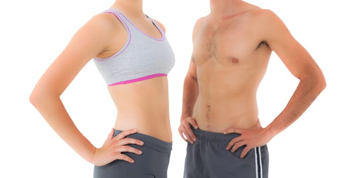 Mid section of a fit young couple standing over white background