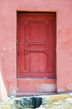 Turda, Romania - June 23, 2013: House facade with pink wood door fron Turda city, Romania