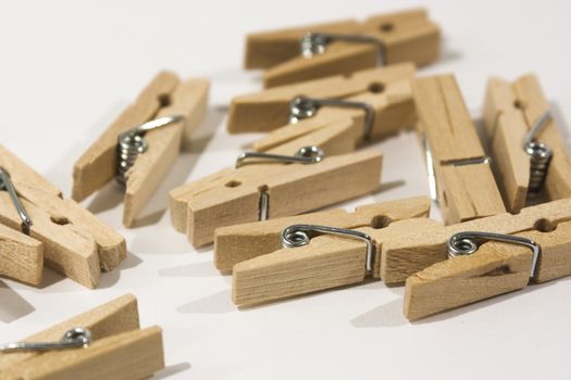 Wooden clothes pegs scattered on a table