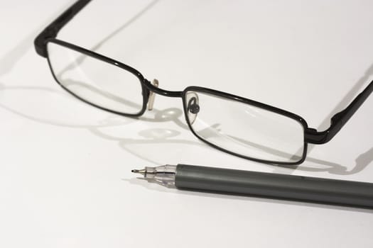 Close up of reading glasses on a white background
