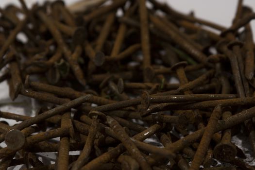 A pile of rusty nails spread out on a table