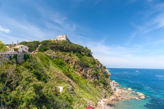 View of the bay and old fortress on a rock, Tuscany, Italy.