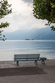 empty lonely bench overlooking the lake Maggiore, Italy