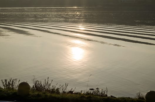 Sun Reflection leg at dusk on a lake.