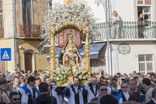 LOULE,PORTUGAL-APRIL19, 2015: man are bringing the 600 kg heavy statue of the Holy Maria to the church in Loule on April 19 2015,This proccesion called Festa da Mae Soberana is 14 days after easter
