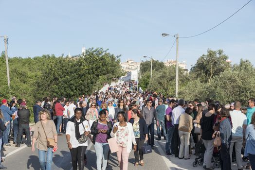 LOULE,PORTUGAL-APRIL19, 2015: poeple gathering together for the procession of  bringing the 600 kg heavy statue of the Holy Maria to the church in Loule on April 19 2015,This proccesion called Festa da Mae Soberana is 14 days after easter