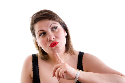 Attractive middle-aged woman deep in thought staring pensively up into the air with her finger to her chin as she makes her decisions or struggles for an answer to a problem