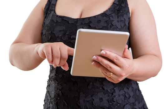 Close up of the torso and hands of a buxom woman in a stylish black dress browsing on a tablet computer in a mobility, communication and modern technology concept