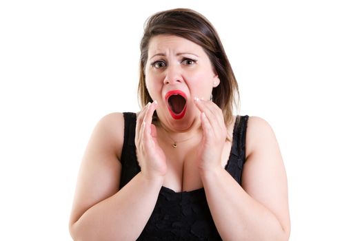 Scared woman with staring eyes and dilated pupils raising her hands to her mouth in terror as she screams out, isolated on white