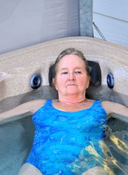 Mature female beauty enjoying her hot tub.