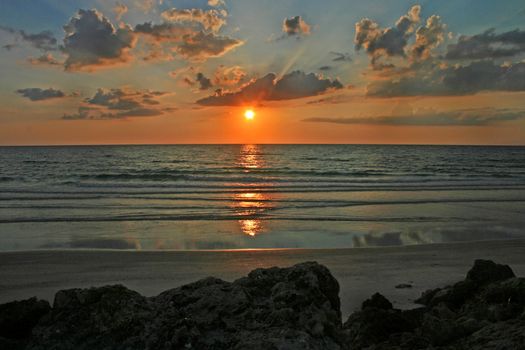 A sunset with clouds over the ocean