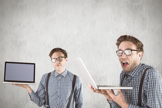 Nerd with laptop against white and grey background