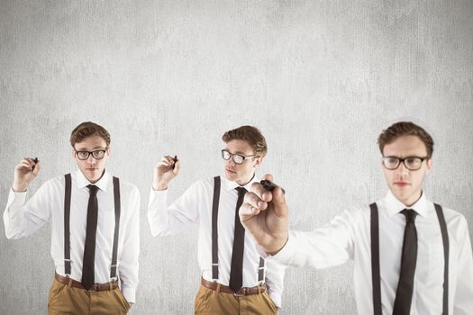 Nerdy businessman writing against white and grey background