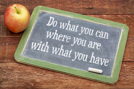 Do what you can, where you are, with what you have  - motivational words on a slate blackboard against red barn wood