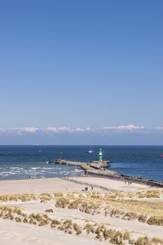 Beach of Warnemunde Germany with lighthouse on the Baltic Sea and blue sky with free space