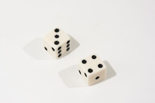 White dice shot against a white background