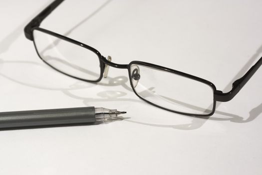 Close up of reading glasses on a white background