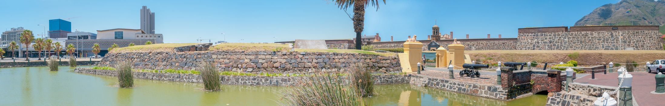 CAPE TOWN, SOUTH AFRICA - DECEMBER 18, 2014:  Panorama of the moat, the Castle of Good Hope and part of the central business district with Devils Peak in the back