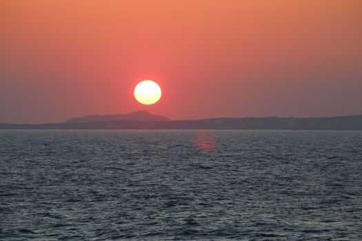 Sunset at the Portara Gate of the Apollo Temple in Naxos island