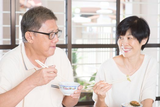 Senior Couple Eating Meal At Home. Asian family living lifestyle.