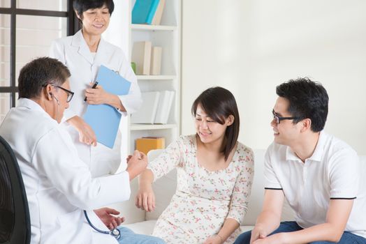 Asian couple consult doctor. Woman health concept.