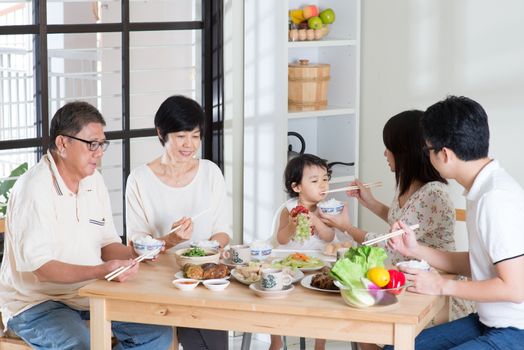 Asian family eating at home. Multi generation having meal, living lifestyle.