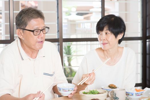 Asian Senior couple having meal at home. Family living lifestyle.