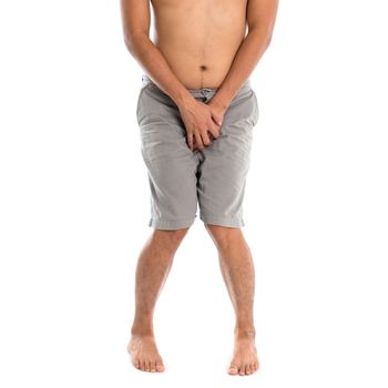 Asian man needing to urinate by covering his crotch with both hands, isolated on white background