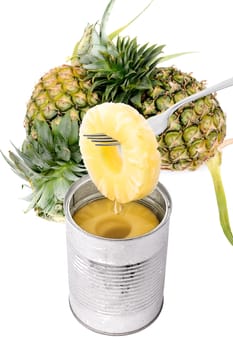 Slice of pineapple on a fork with fresh fruit