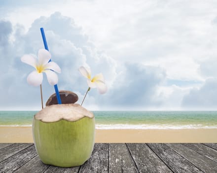 Fresh coconut drink with nice beach background