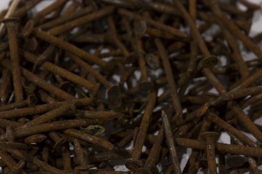 A pile of rusty nails spread out on a table