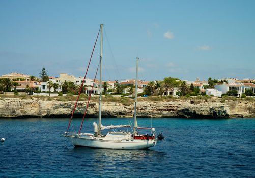 Small Yacht in Beauty Harbor near Coast of Menorca, Balearic Islands 