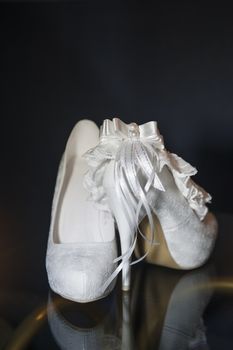 beautiful elegant bride shoes on a black background.