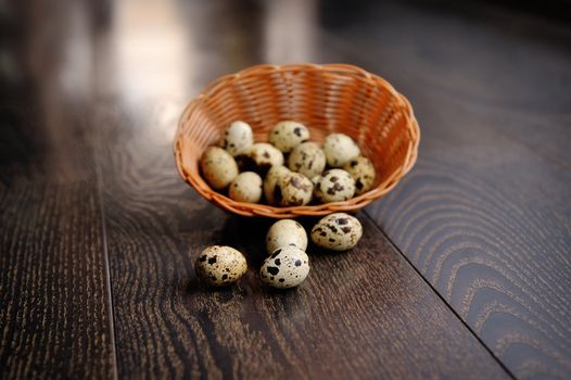 easter basket with easter eggs on wooden background.