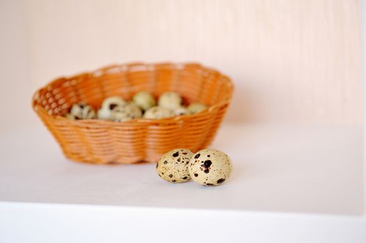 Easter basket with decorated eggs on table.