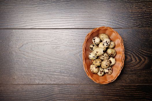 easter basket with easter eggs on wooden background