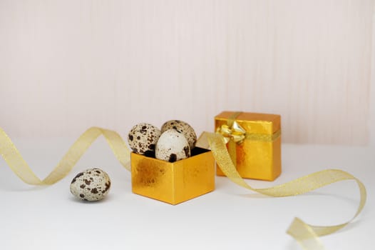 golden box with Easter eggs and ribbon.