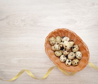 Easter eggs in a basket and a yellow ribbon.
