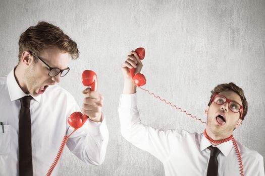 Nerdy businessman with phone  against white and grey background