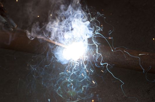 Welding steel pipe, bright light smoke spark electric arc