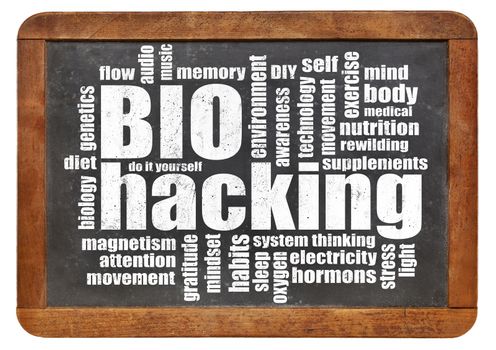 biohacking -  managing one's own biology using a combination of medical, nutritional and electronic techniques - word cloud on a blackboard