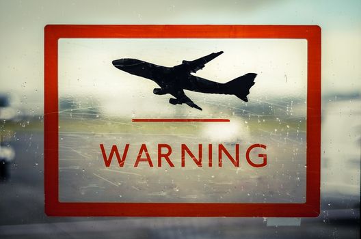 A Red Airport Warning Sign With Aircraft Taking-Off