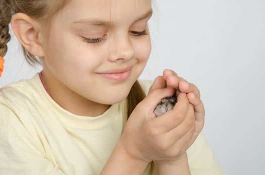 Six year old girl smiling holding pens in the hamster