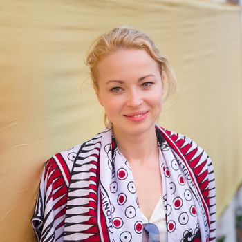 Caucasian, Blonde, Female Traveler Visiting Buddhist Temple of Wat Arun in Bangkok, Thailand.