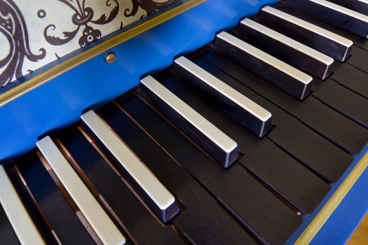Detail of old harpsichord keyboard with black keys, close-up view
