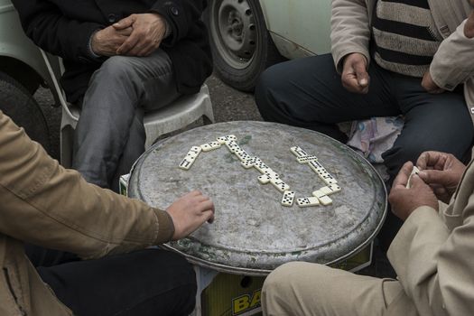 Group of men playing domino on free time.