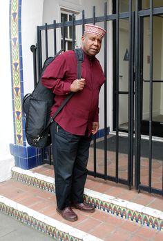 Muslim jazz musician with his saxophone outside.