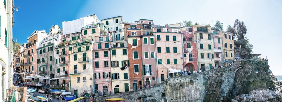 RIOMAGGIORE, ITALY - SEPTEMBER 21, 2014: Tourists walk along town narrow streets. Riomaggiore is the most southern village of the five Cinque Terre, all connected by trail.