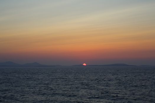 Sunset at the Portara Gate of the Apollo Temple in Naxos island